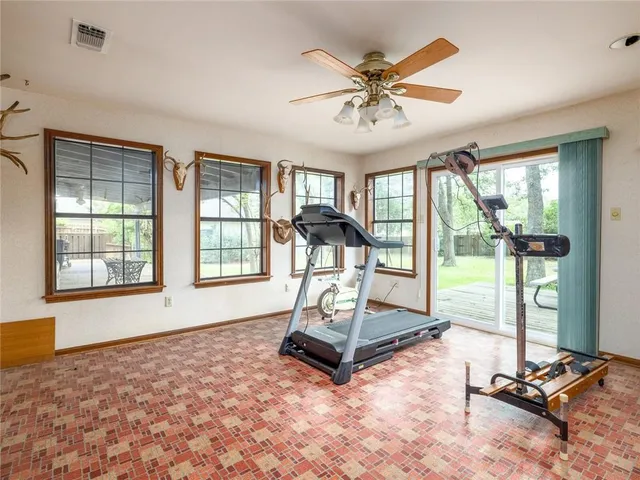 a view of a room with gym equipment and floor to ceiling window
