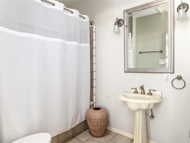 a bathroom with a sink toilet and a mirror