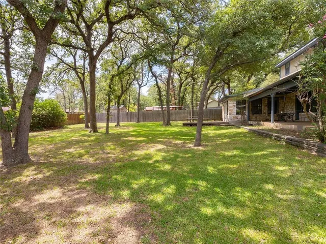 a swimming pool with outdoor seating and yard
