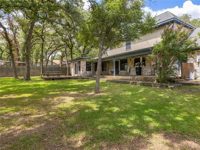 a front view of a house with a yard table and chairs