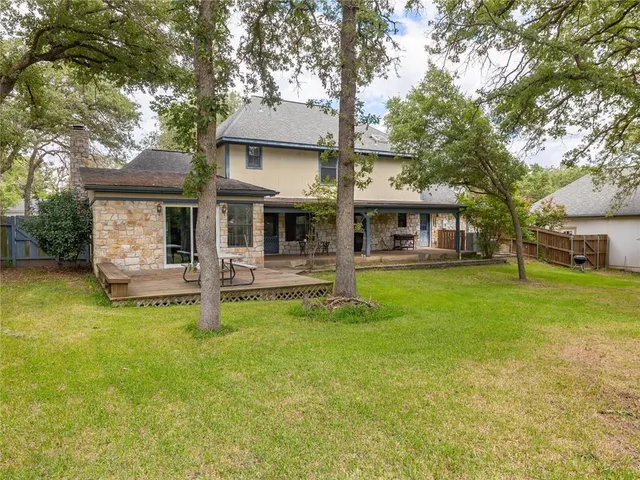 a front view of a house with swimming pool and sitting area
