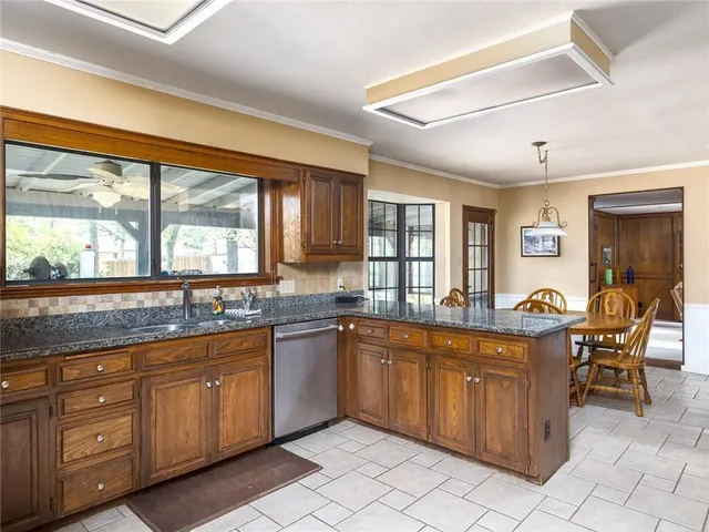 a kitchen with a sink and wooden cabinets