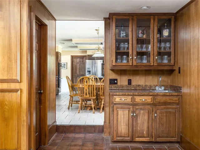 a dining room with wooden floor and hallway