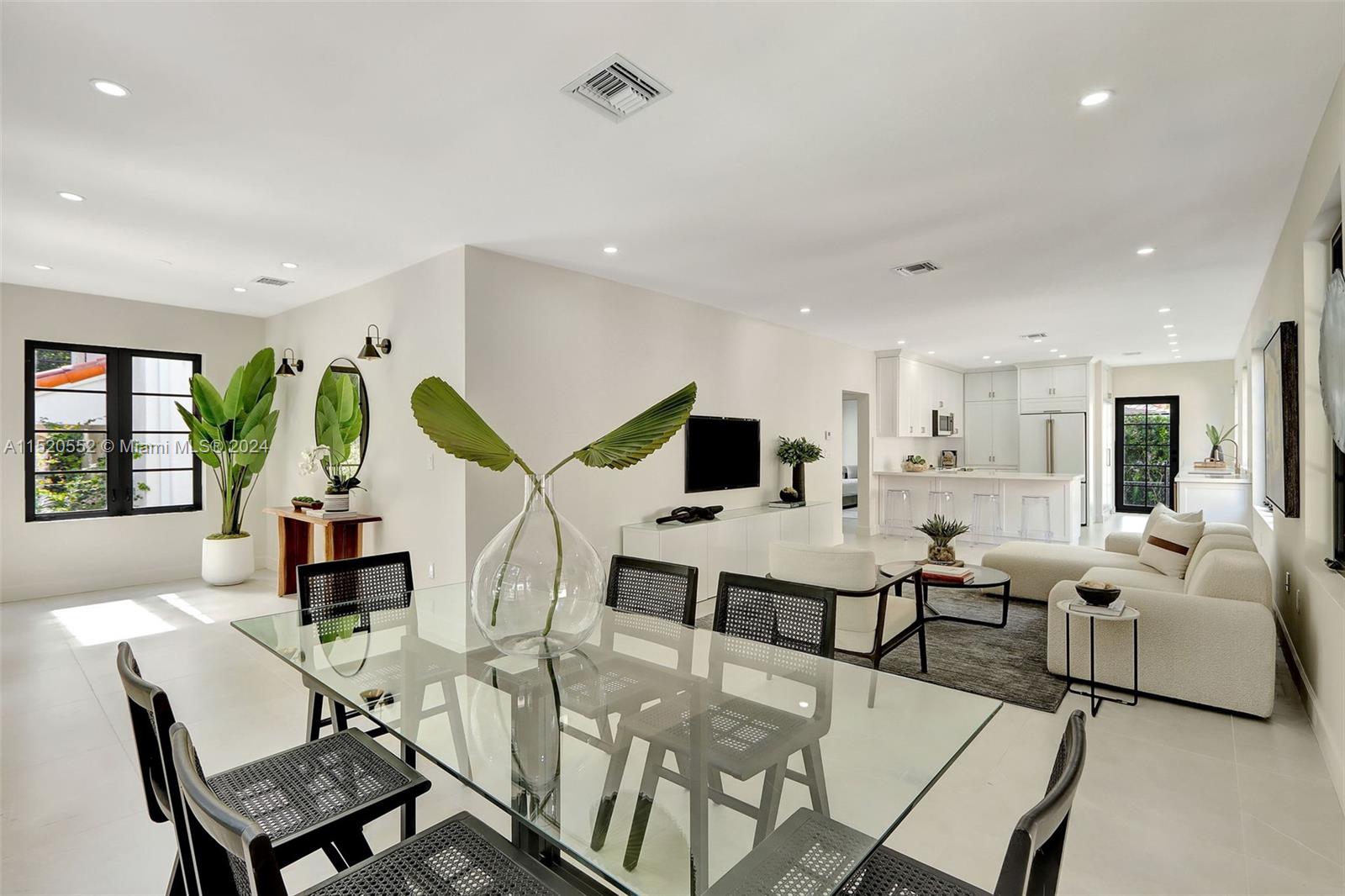 Granada Coral Gables, FL 33134 - Photo 13 of 36 a living room with lots of furniture and paintings on the wall