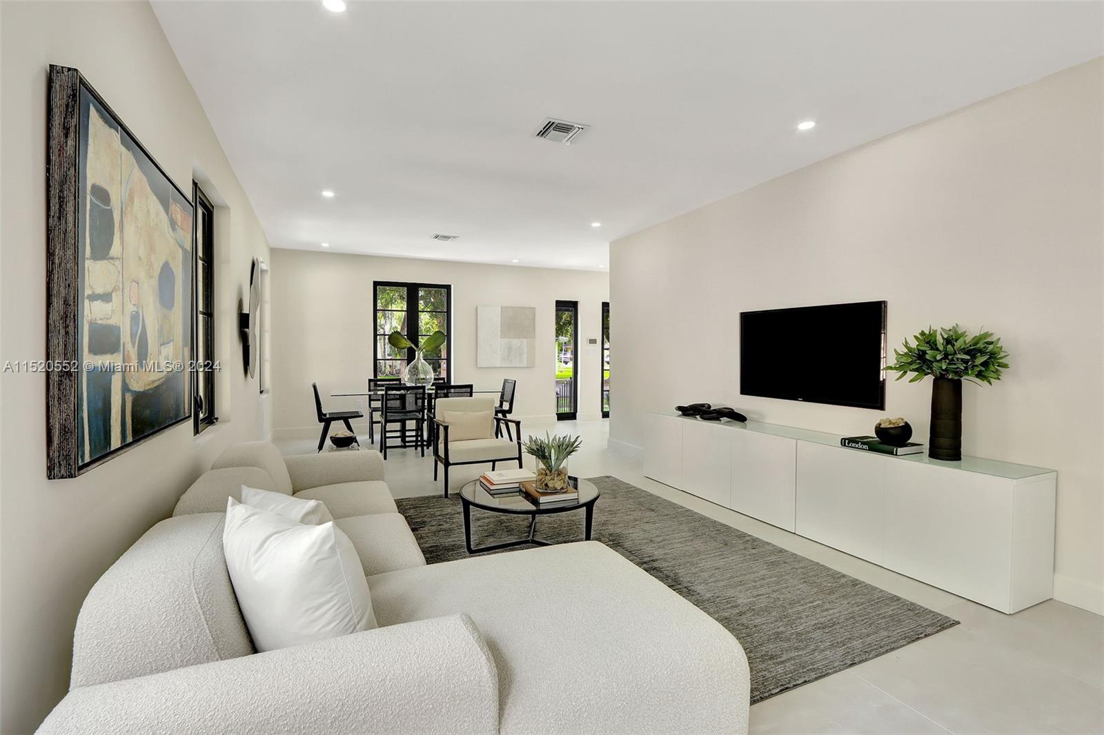 Granada Coral Gables, FL 33134 - Photo 14 of 36 a living room with furniture and a flat screen tv