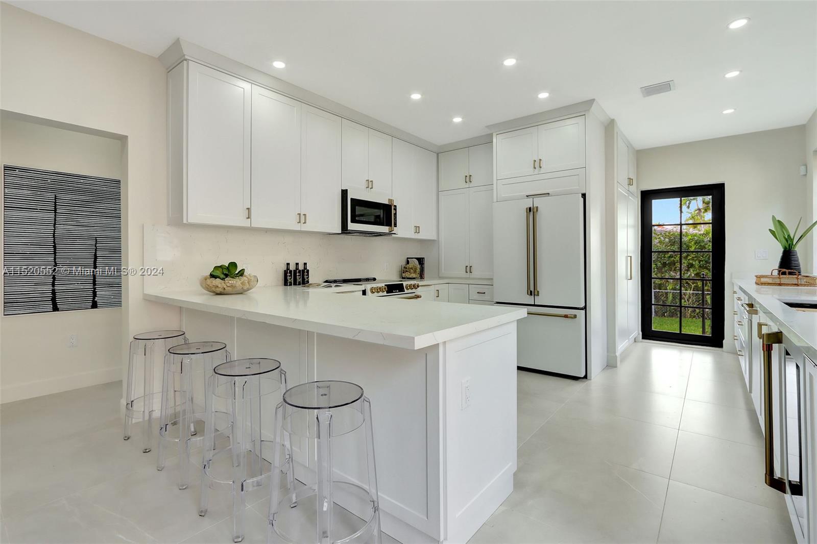 Granada Coral Gables, FL 33134 - Photo 17 of 36 a kitchen with stainless steel appliances a refrigerator sink and cabinets
