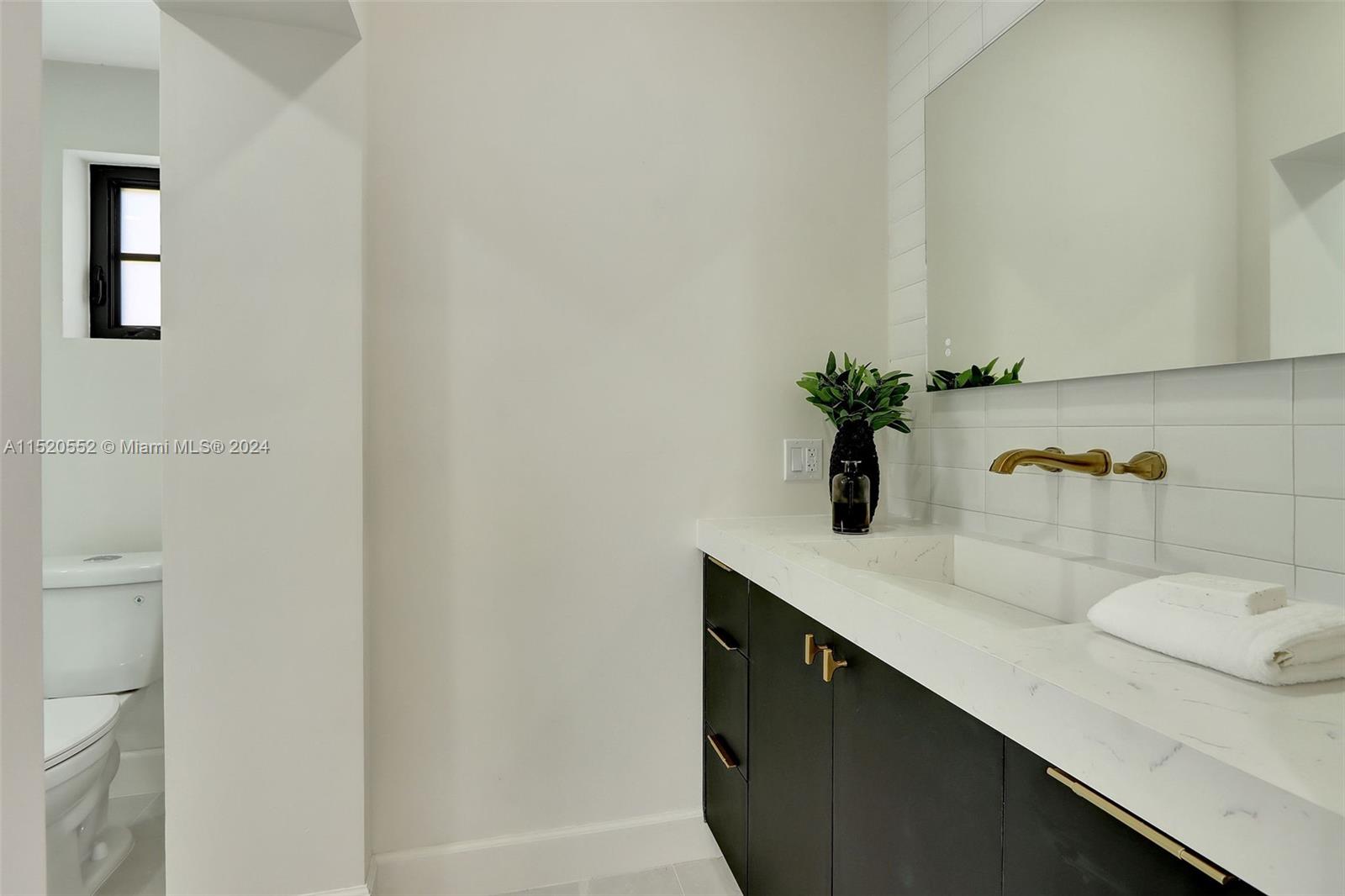 Granada Coral Gables, FL 33134 - Photo 24 of 36 a bathroom with a sink and a mirror