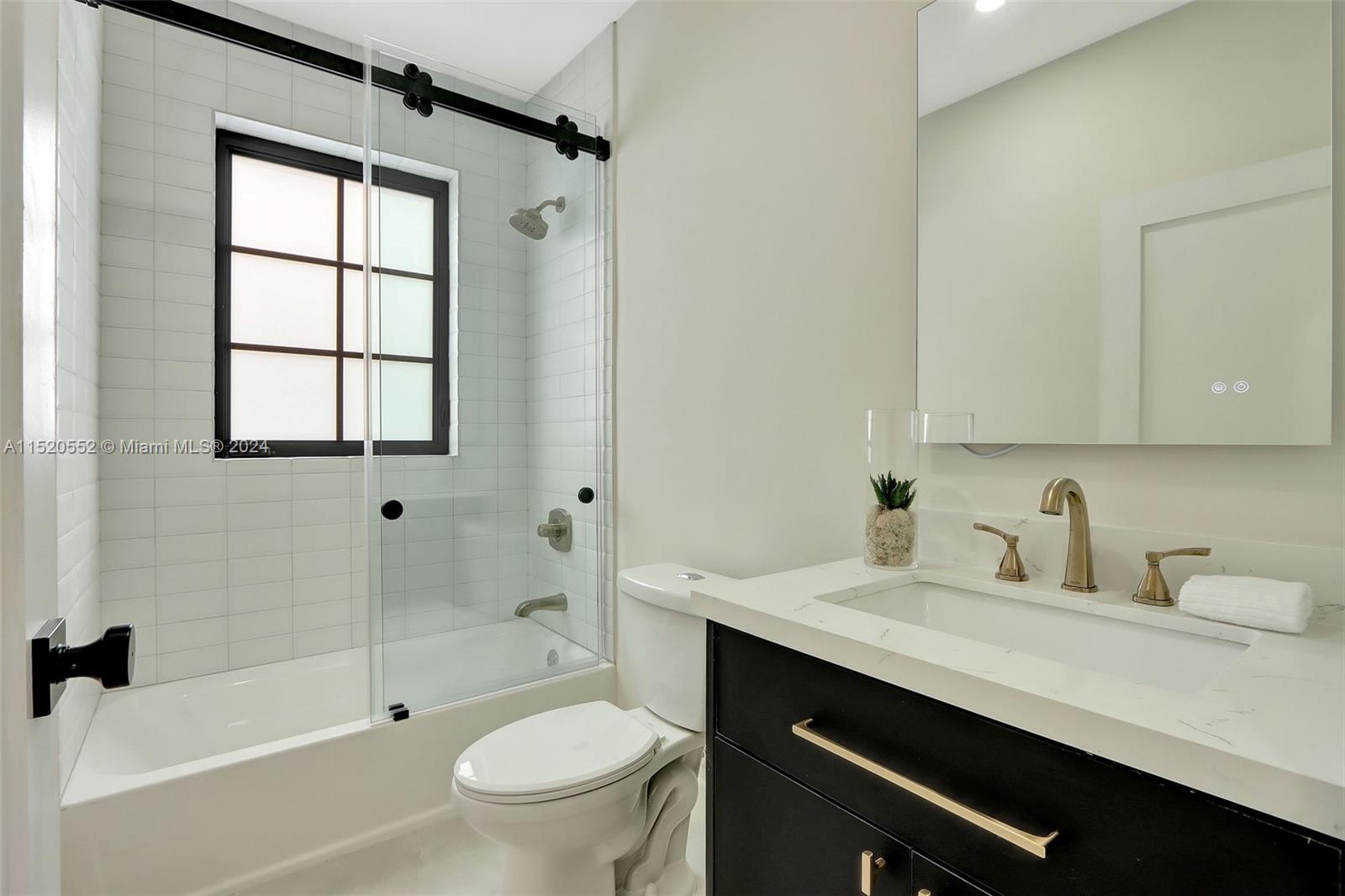 Granada Coral Gables, FL 33134 - Photo 29 of 36 a bathroom with a sink a toilet and shower