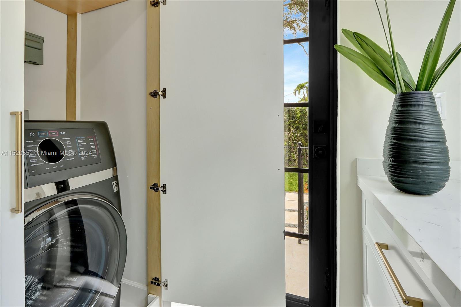 Granada Coral Gables, FL 33134 - Photo 31 of 36 a view of a hallway with washer and dryer