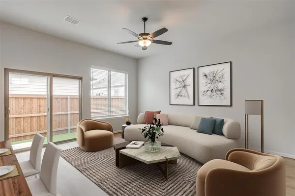 a living room with furniture and floor to ceiling windows