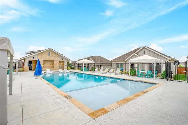 a view of a white house with a big yard and large trees