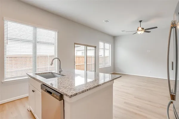 a kitchen with granite countertop a sink and a window