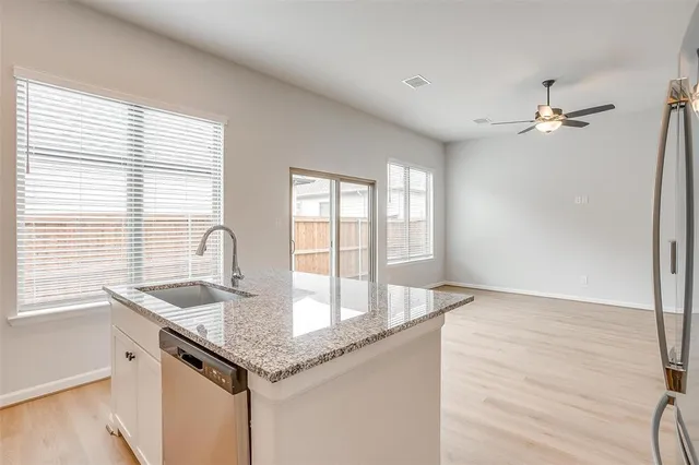 a kitchen with granite countertop a sink and a window