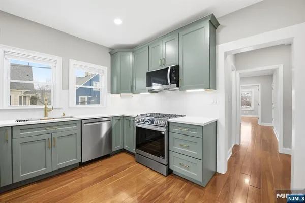 a kitchen with stainless steel appliances granite countertop a stove and a sink