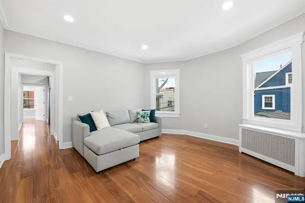 a living room with furniture and wooden floor