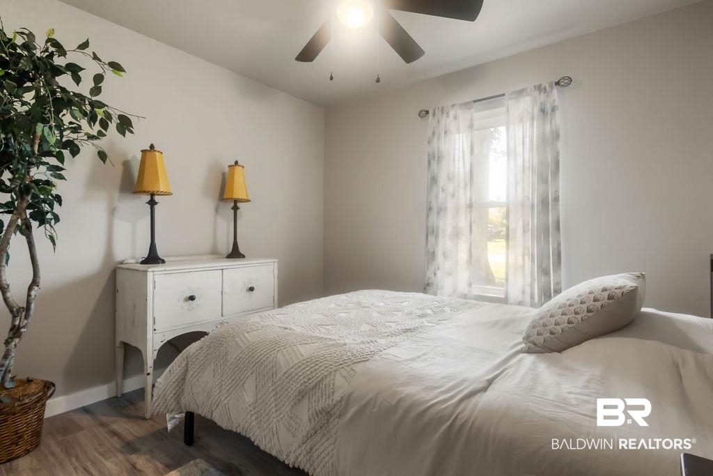 601 East Gate Circle Foley, AL 36535 - Photo 8 of 26 Bedroom featuring ceiling fan and wood-type flooring