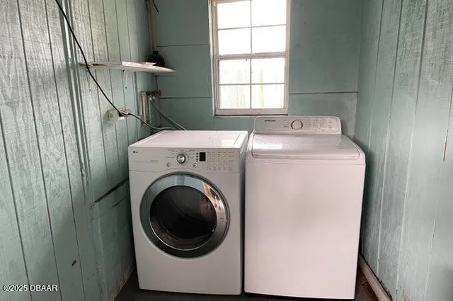 a view of a porch with furniture and floor to ceiling window
