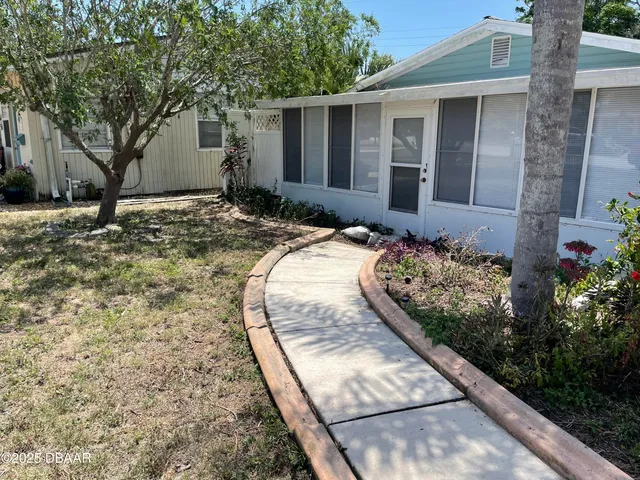 a view of a house with a backyard