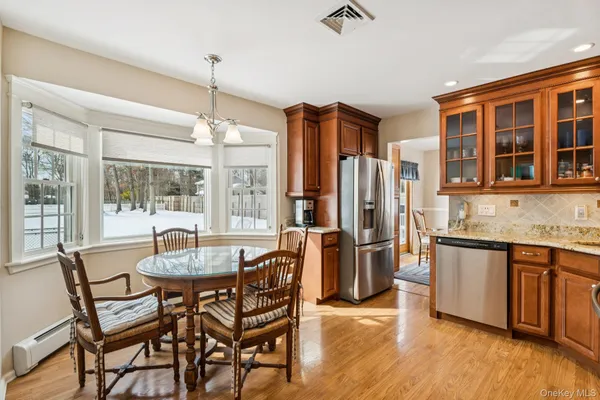 a kitchen with stainless steel appliances granite countertop a stove and cabinets