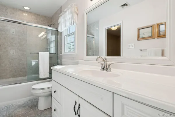 a view of a workspace with wooden floor and a window