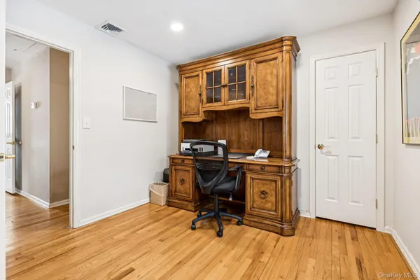 a view of a bedroom with wooden floor and a window