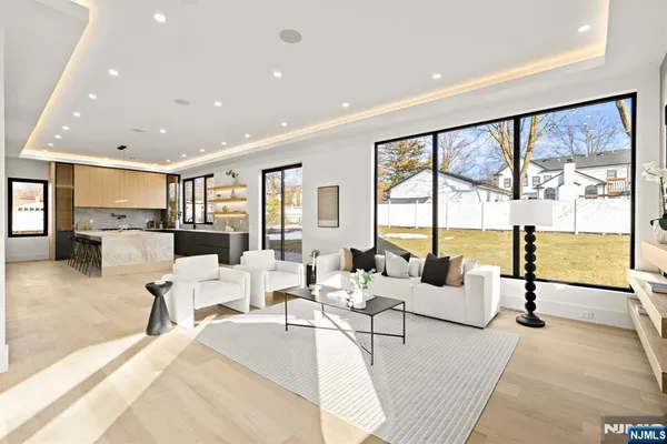 a living room with furniture and floor to ceiling window