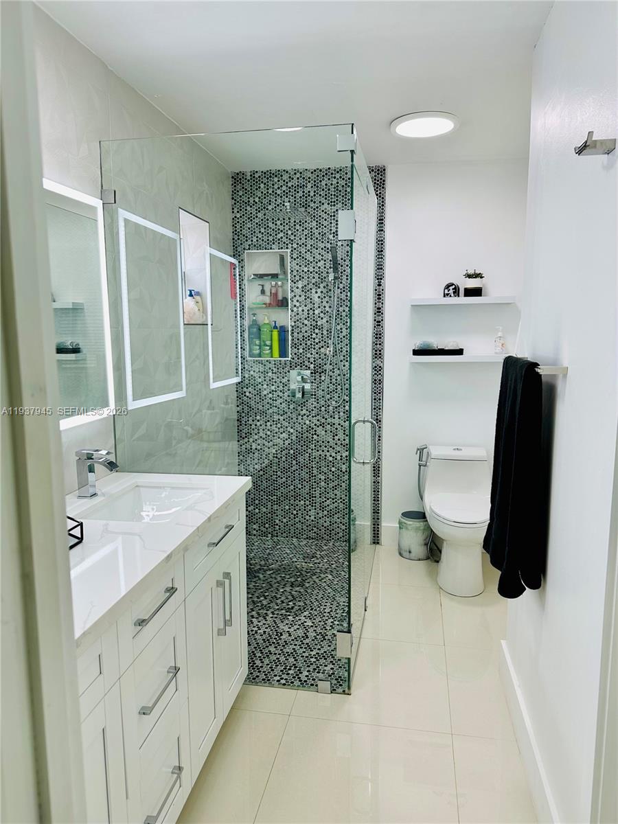 8410 Southwest 201st Street Cutler Bay, FL 33189 - Photo 17 of 32 a bathroom with a sink and a mirror