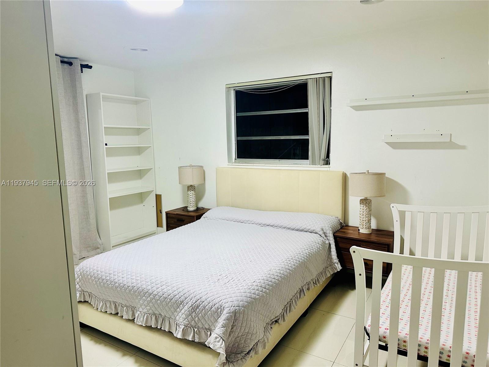 8410 Southwest 201st Street Cutler Bay, FL 33189 - Photo 23 of 32 a bedroom with a bed and a flat tv screen