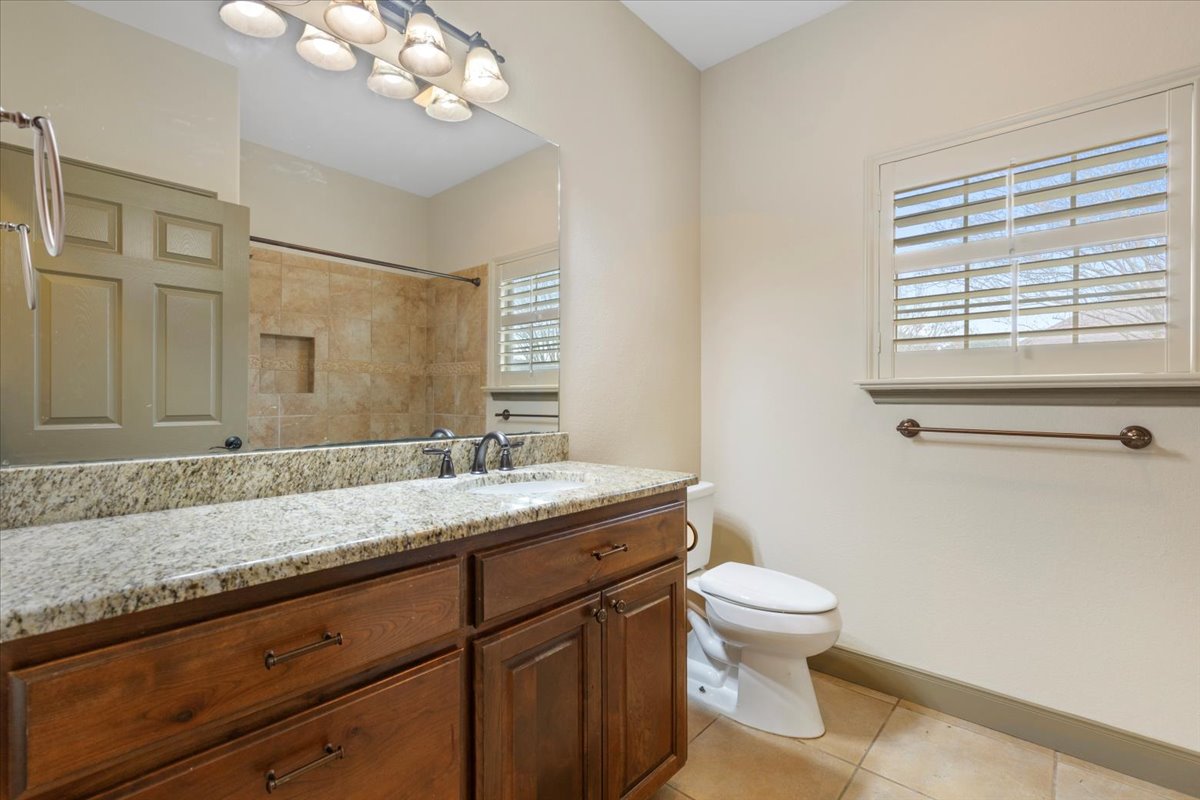 106 Spring Meadow Road Bastrop, TX 78602 - Photo 30 of 39 Full bathroom with vanity, light tile patterned floors, and a shower