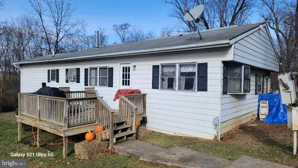 a view of a house with a yard deck and deck