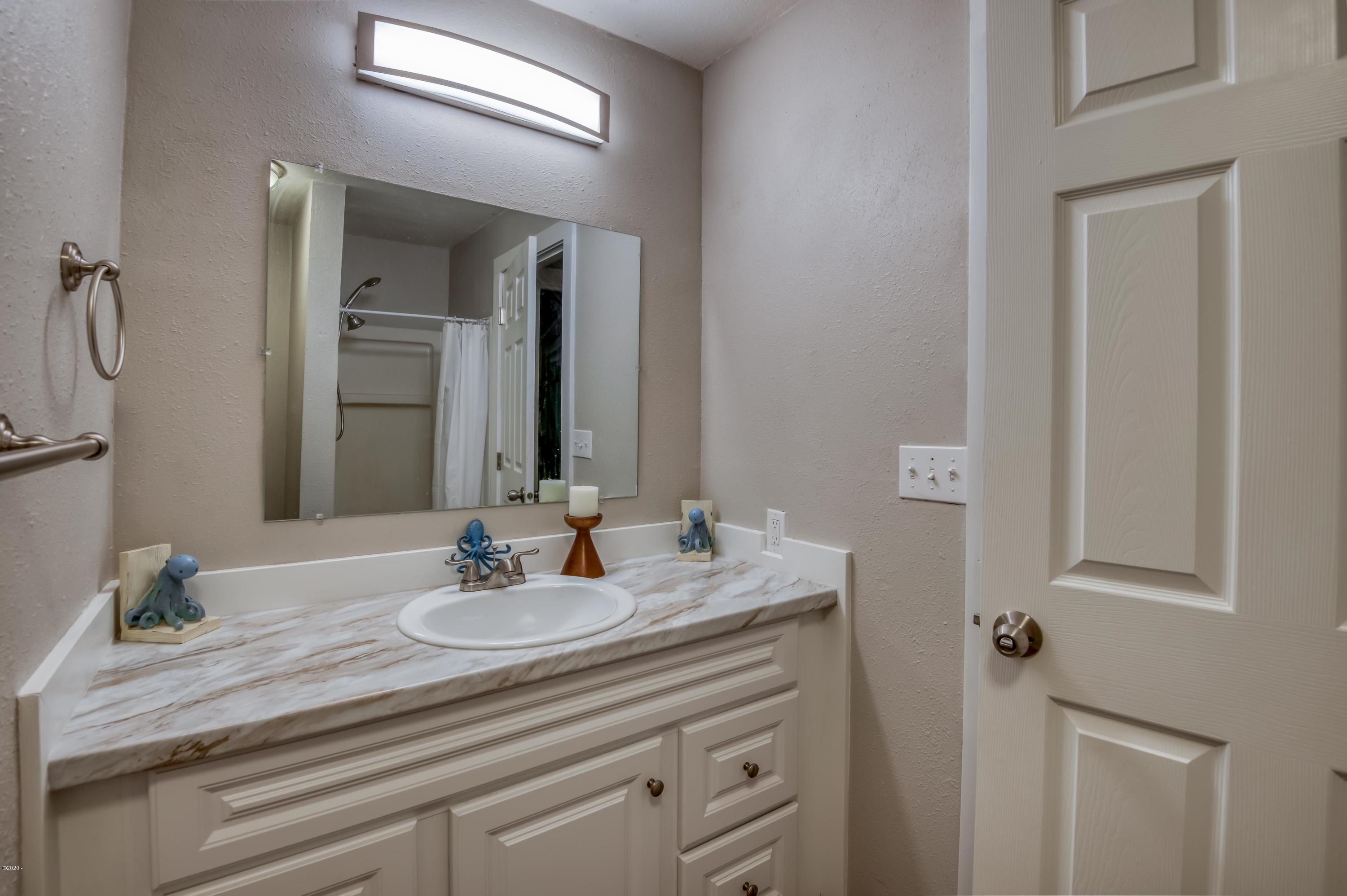 3038 Northeast East Line Road Yachats, OR 97498 - Photo 15 of 24 a bathroom with a sink double vanity and a mirror