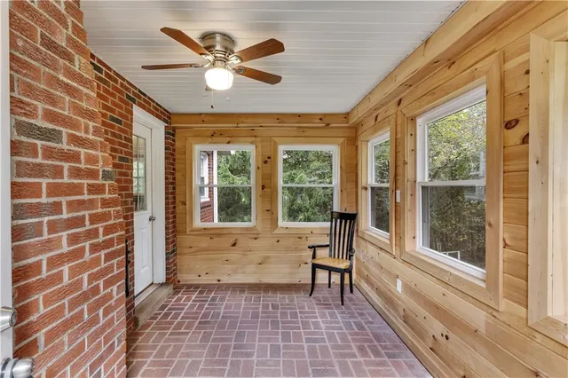 a view of a livingroom with a ceiling fan and a window