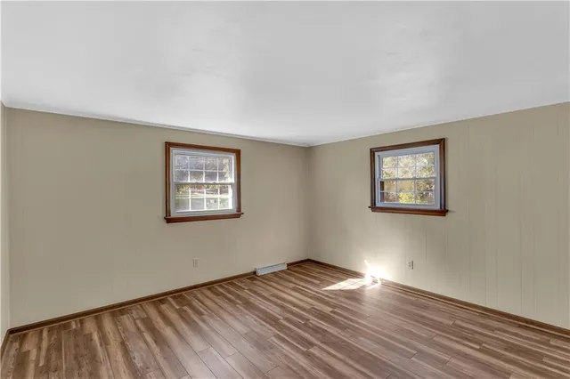 a view of a room with wooden floor and window