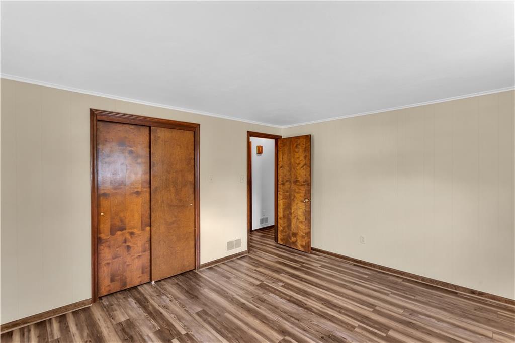 97 Emery Road Fredericktown, PA 15333 - Photo 14 of 23 an empty room with wooden floor and windows