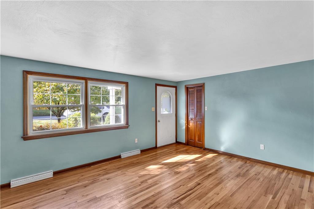 97 Emery Road Fredericktown, PA 15333 - Photo 3 of 23 an empty room with wooden floor and windows