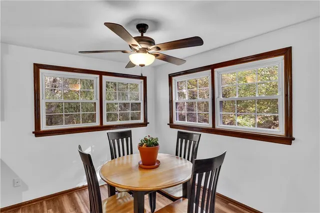 a view of a dining room with furniture window and wooden floor