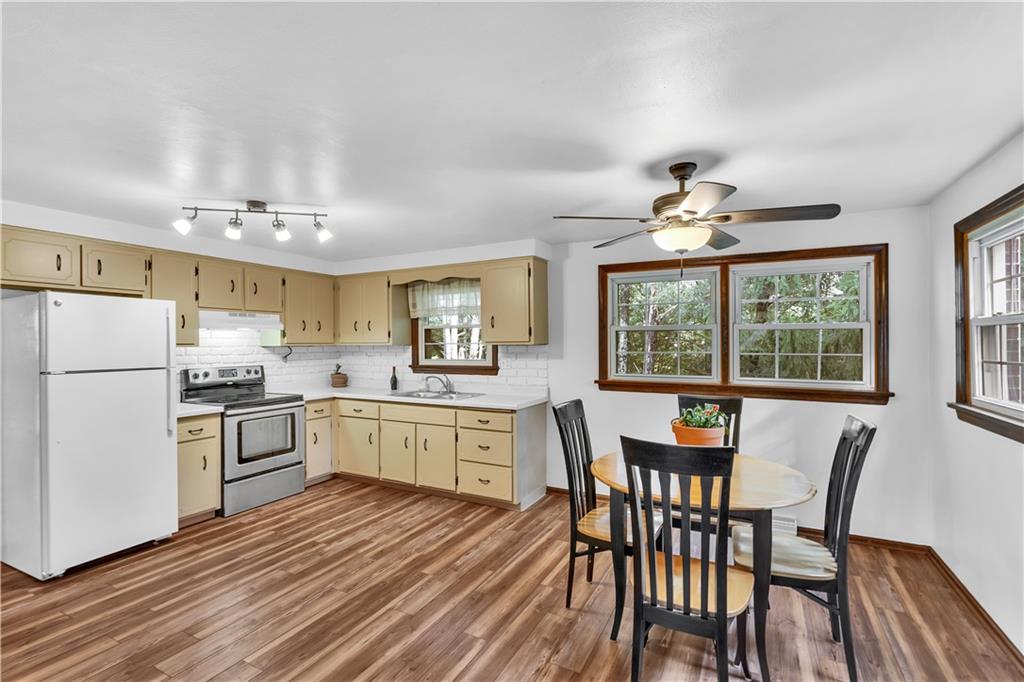 97 Emery Road Fredericktown, PA 15333 - Photo 8 of 23 a kitchen with a table chairs refrigerator and cabinets