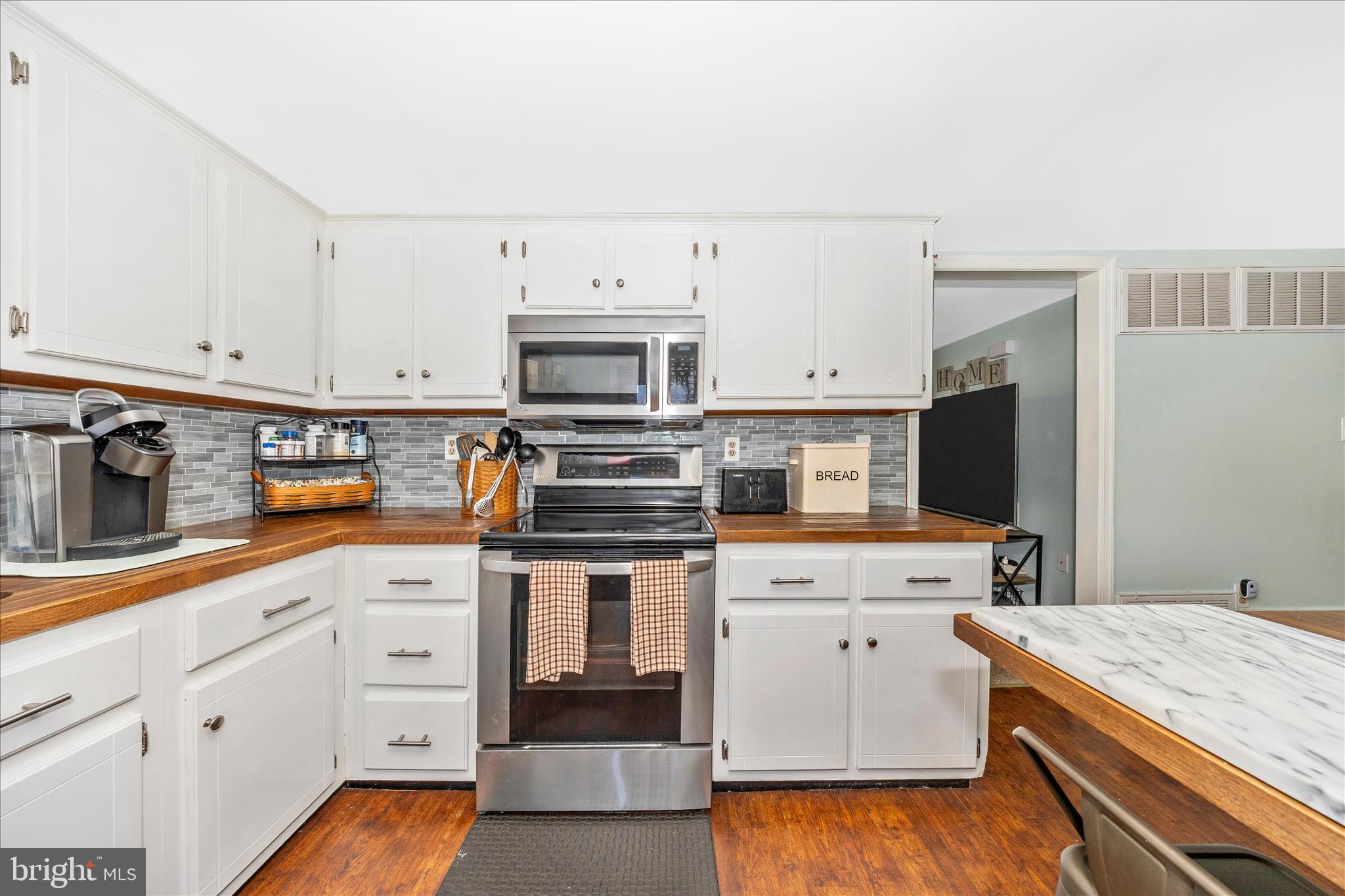 5618 Bartonsville Road Frederick, MD 21704 - Photo 14 of 53 a kitchen with granite countertop white cabinets and white appliances