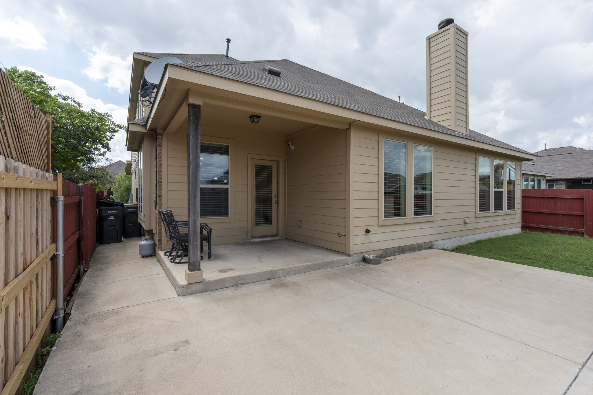 373 Rough Bark Street Buda, TX 78610 - Photo 23 of 39 A private rear yard offers a covered patio and direct home access for relaxed outdoor living.