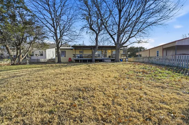 a white house that has a tree in front of it