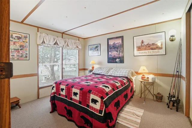 a bedroom with a bed and a painting on the wall