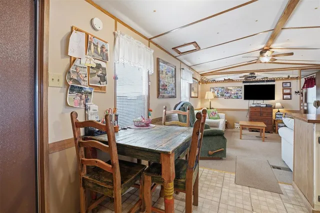 a view of a dining room with furniture and a chandelier