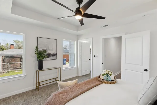 a bedroom with a bed lamp and a chandelier
