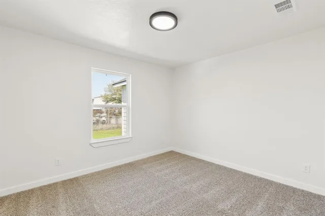 a spacious bathroom with a double vanity sink mirror and toilet