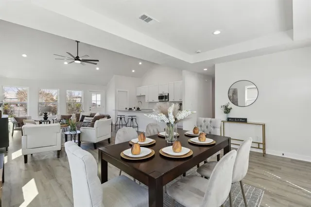 a view of a dining room with furniture and wooden floor
