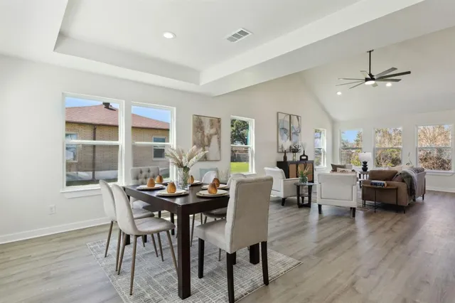 a view of a dining room with furniture and wooden floor