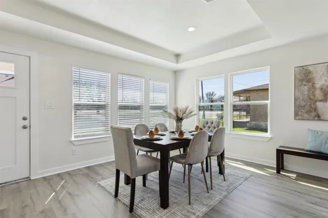 a dining room with furniture and window