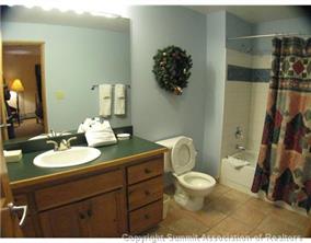195 River Run Road, Unit 8004 Keystone, CO 80435 - Photo 8 of 16 a bathroom with a granite countertop sink a toilet and a mirror