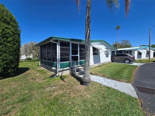 a view of a house with backyard and porch