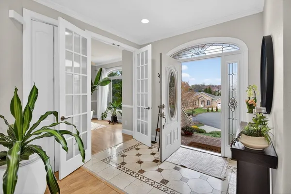 a view of a a dining room with furniture window and wooden floor
